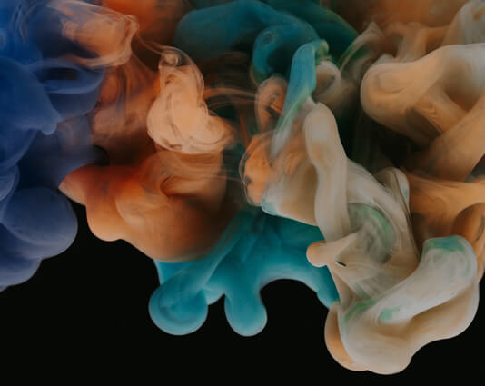 Colorful, swirling liquids that mix together.