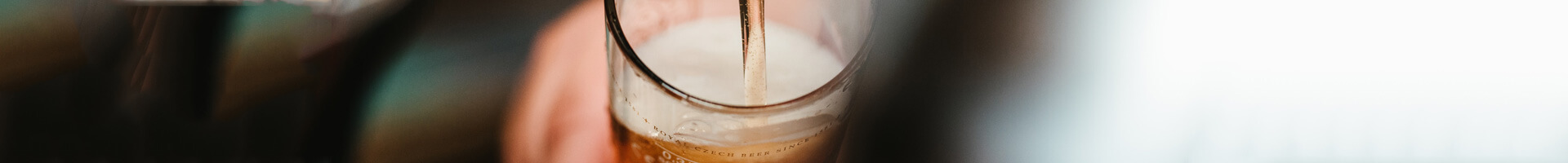 Beer is poured into a beer glass.