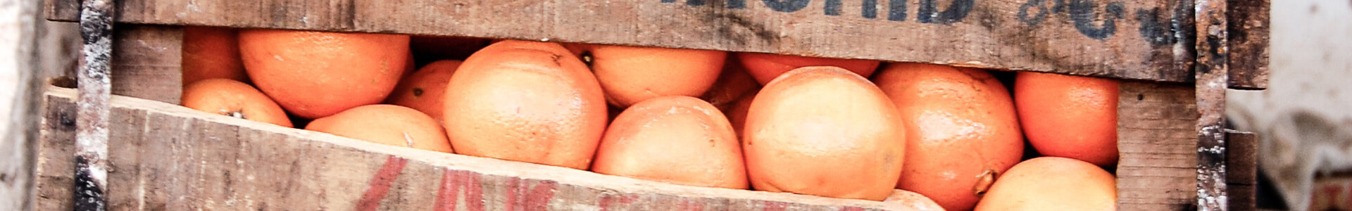 Oranges in a wooden crate.