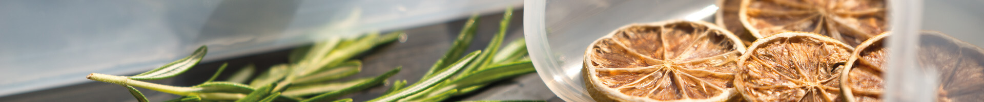 Herbs and dried fruit in plastic containers.